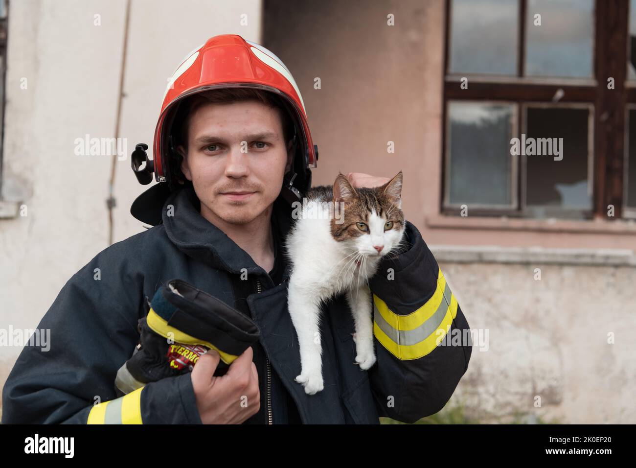 Closeup portrait of heroic fireman in protective suit and red helmet