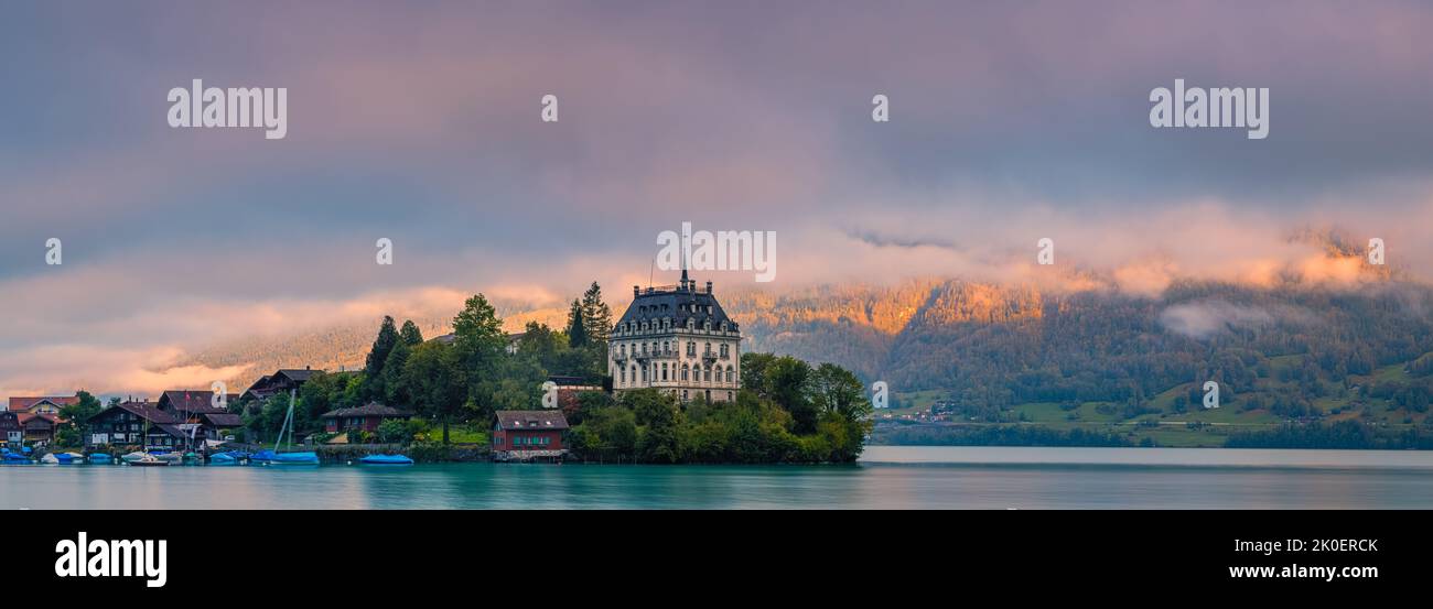 A wide panoramaic image from a beautiful summer sunrise in Iseltwald, one of Switzerland's gems. Located on Lake Brienz southern shores, it is like a Stock Photo