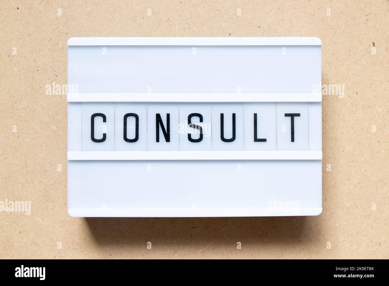 Lightbox with word consult on wood background Stock Photo