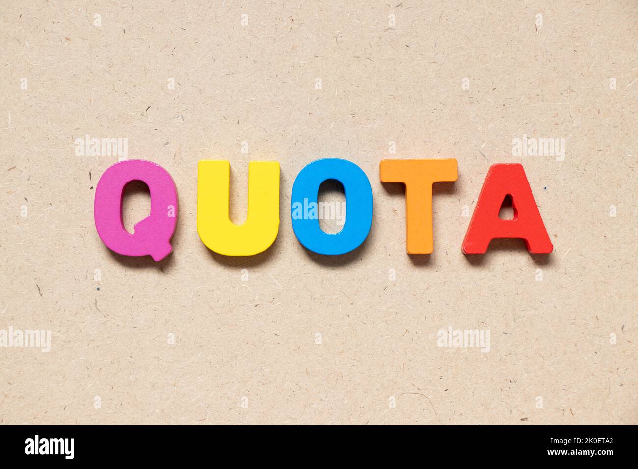 Color alphabet letter in word quota on wood background Stock Photo