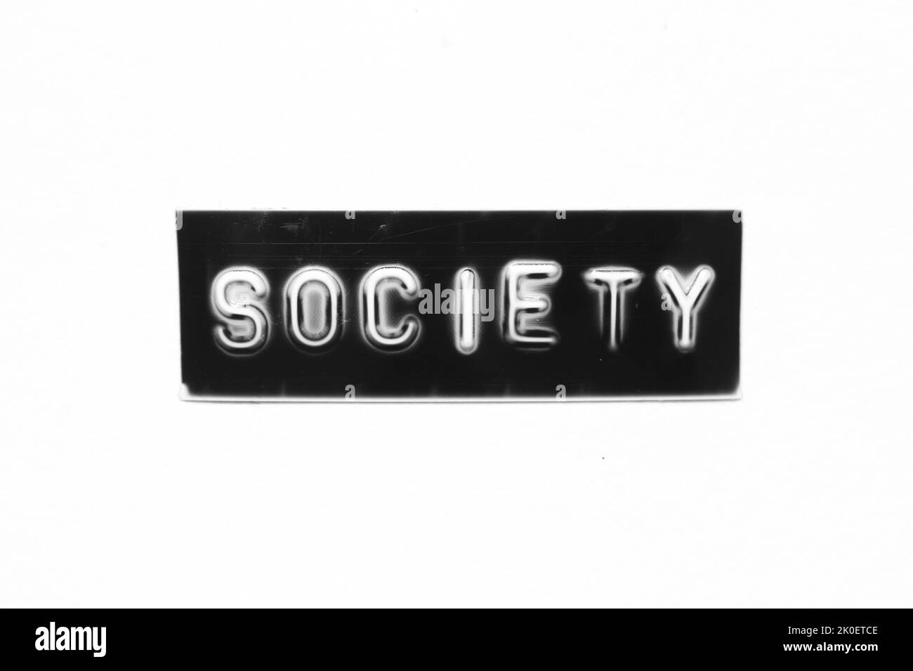 Black color banner that have embossed letter with word society on white paper background Stock Photo