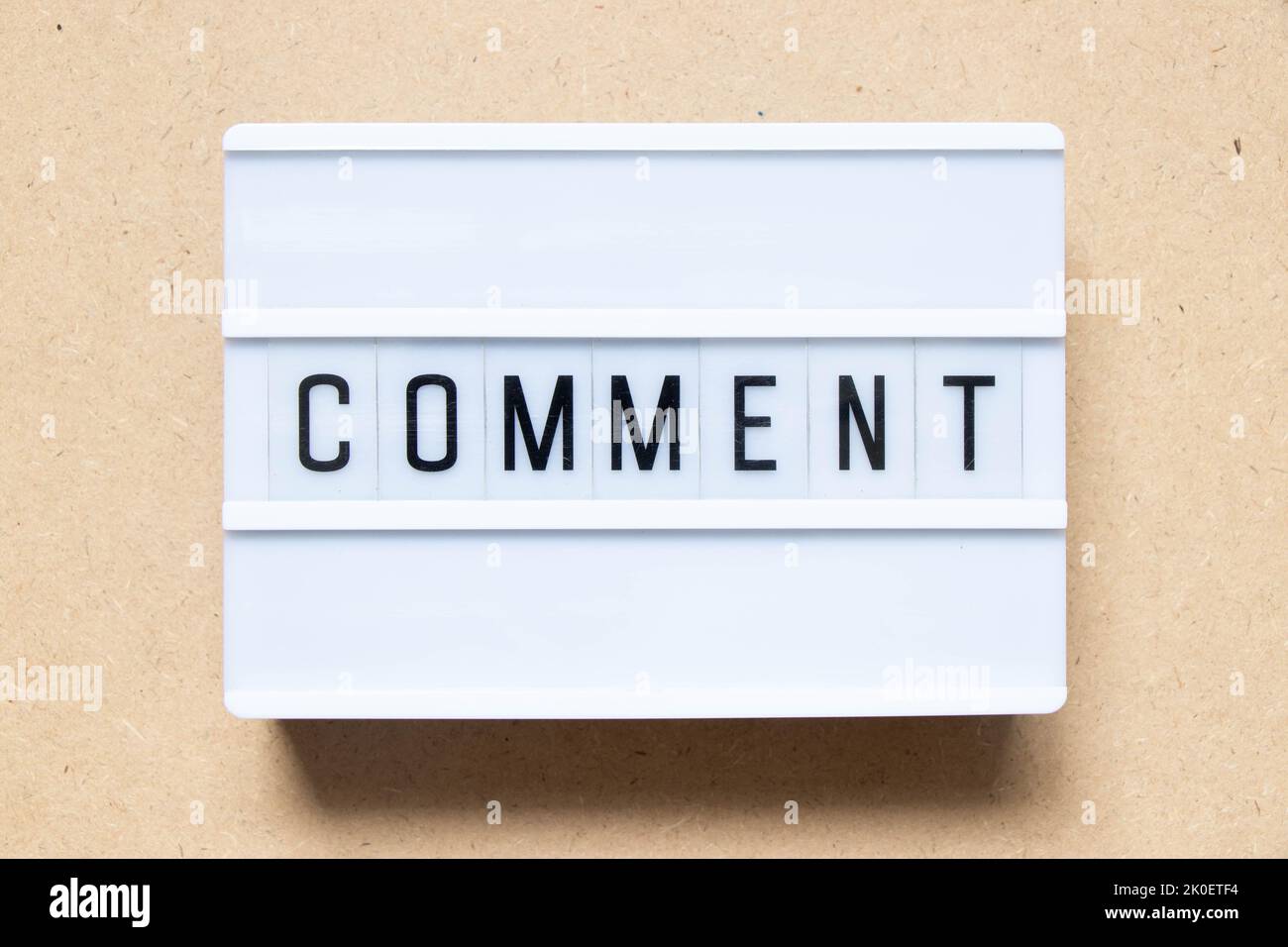 Lightbox with word comment on wood background Stock Photo