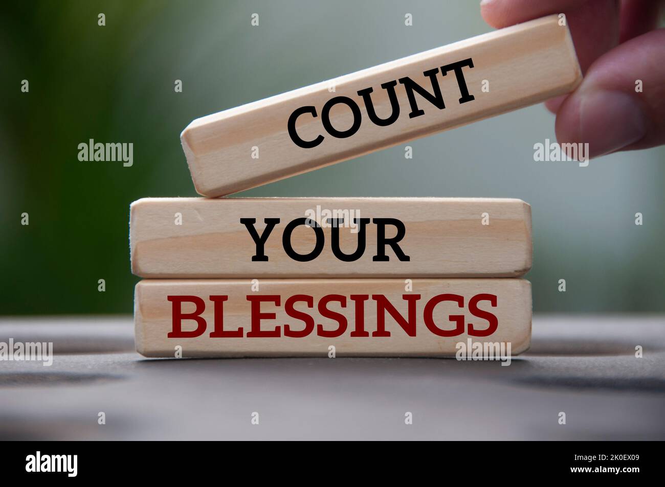 Count your blessings text on wooden blocks with blurred park background