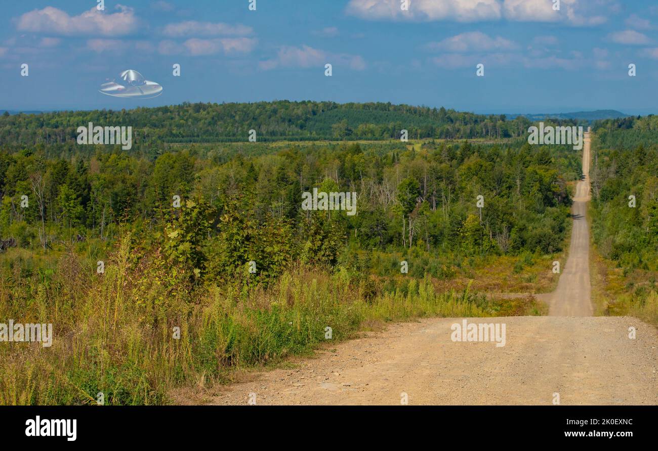 Remote dirt road with a flying saucer of the forest in Maine Stock Photo