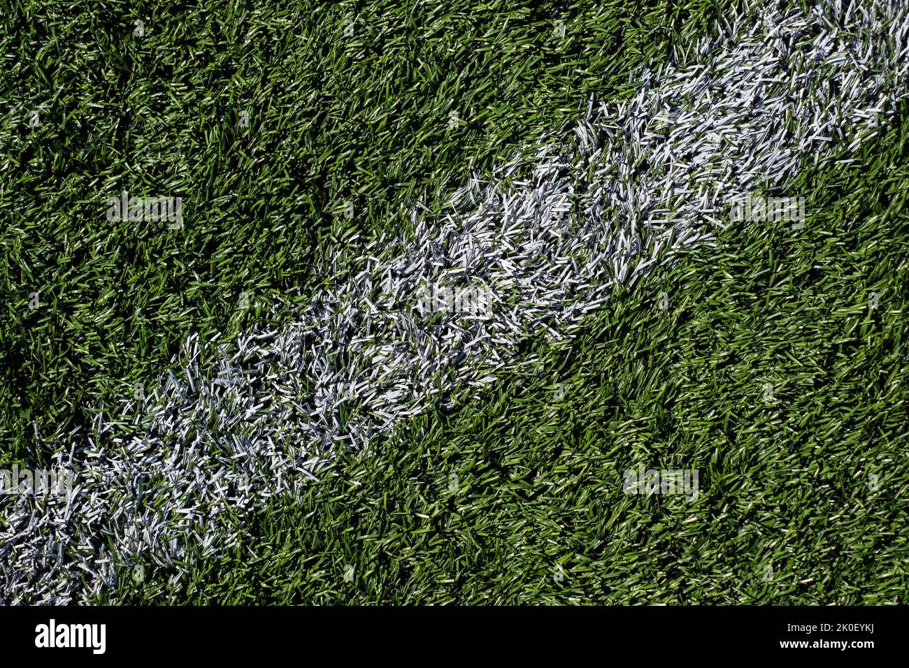 Green football grass background with white line. Soccer stadium field. Stock Photo