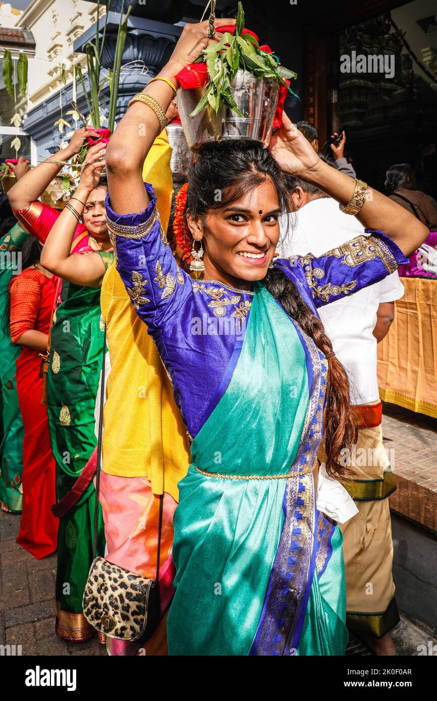 Lewisham, London, UK. 11th Sep, 2022. Many women hold pots filled with milk (considered pure) on their heads as offerings to the gods.Worshippers mark the Tamil Chariot Festival  with a colourful celebration. Out of respect for the Queen, the procession is today restricted to just the Sivan Kovil temple and courtyard. Normally, around 5,000 visitors and participants would proceed from the temple through the town centre carrying large chariots and offerings. Credit: Imageplotter/Alamy Live News Stock Photo