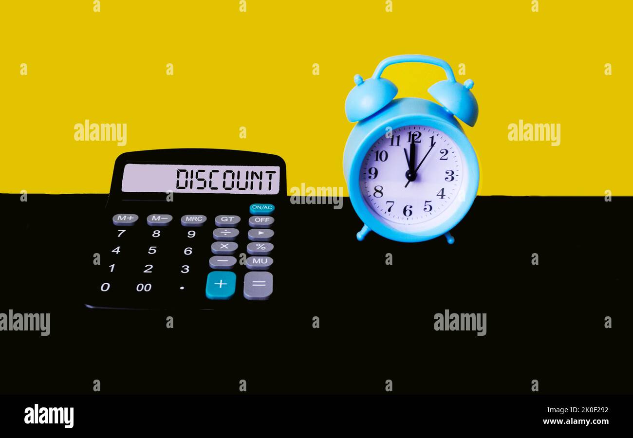 Discount word on calculator display screen on yellow and black background with clock. The concept of calculating discounts. Stock Photo