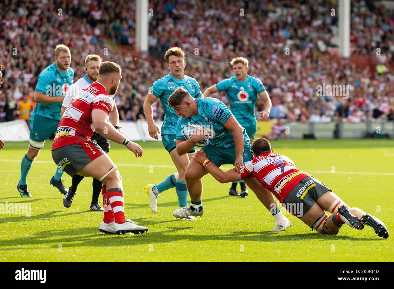 Dan Frost of Wasps Rugby is tackled by Harry Taylor of Gloucester Rugby
