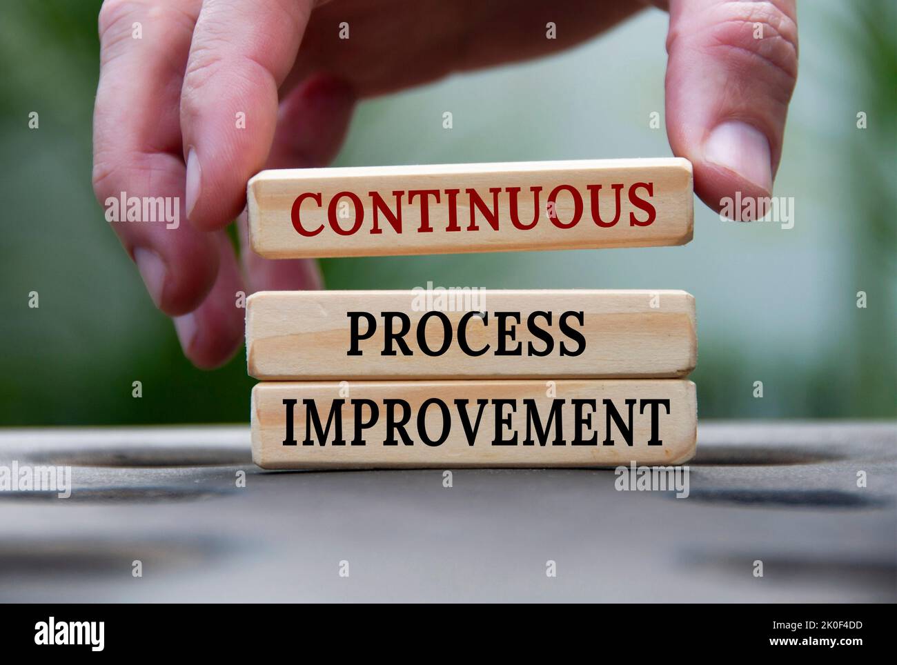 Continuous process improvement text on wooden blocks with blurred nature background. Process improvement and business concept. Stock Photo