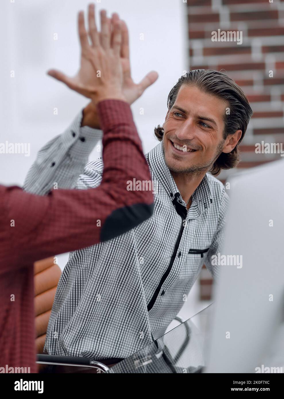 happy employees giving each other high five Stock Photo - Alamy
