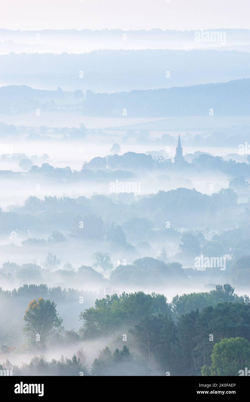 The steeple of St Barnabas Church in Weeton is prominent amongst the layered rural landscape of Arthington Pastures on a misty autumn morning. Stock Photo