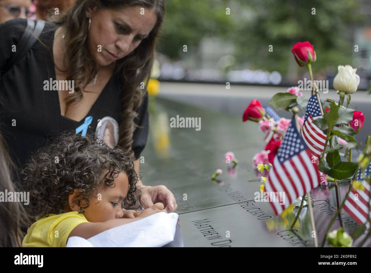 New York, United States. 11th Sep, 2022. Family of Rosa Maria Feliciano, who died in the North Tower during the September 11 attacks on the World Trade Center, etch her name onto paper on the 21st anniversary of the attacks in New York City on Sunday, September 11, 2022. Photo by Bonnie Cash/UPI Credit: UPI/Alamy Live News Stock Photo