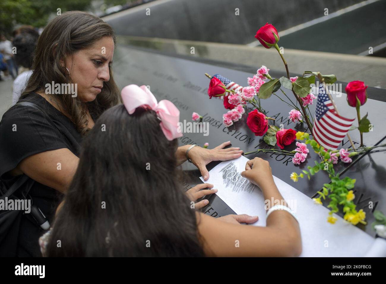 New York, United States. 11th Sep, 2022. Family of Rosa Maria Feliciano, who died in the North Tower during the September 11 attacks on the World Trade Center, etch her name onto paper on the 21st anniversary of the attacks in New York City on Sunday, September 11, 2022. Photo by Bonnie Cash/UPI Credit: UPI/Alamy Live News Stock Photo