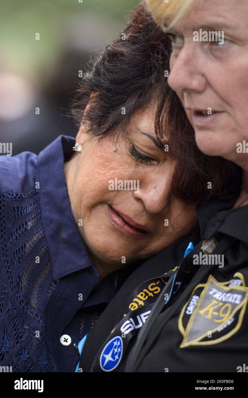 New York, United States. 11th Sep, 2022. A crying woman is comforted ...
