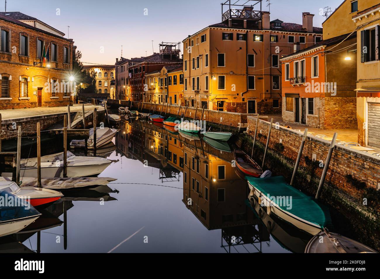 Water canal at dusk,Venice,Italy.Typical boat transportation,Venetian travel urban scene.Water transport.Popular tourist destination.Romantic calm Stock Photo