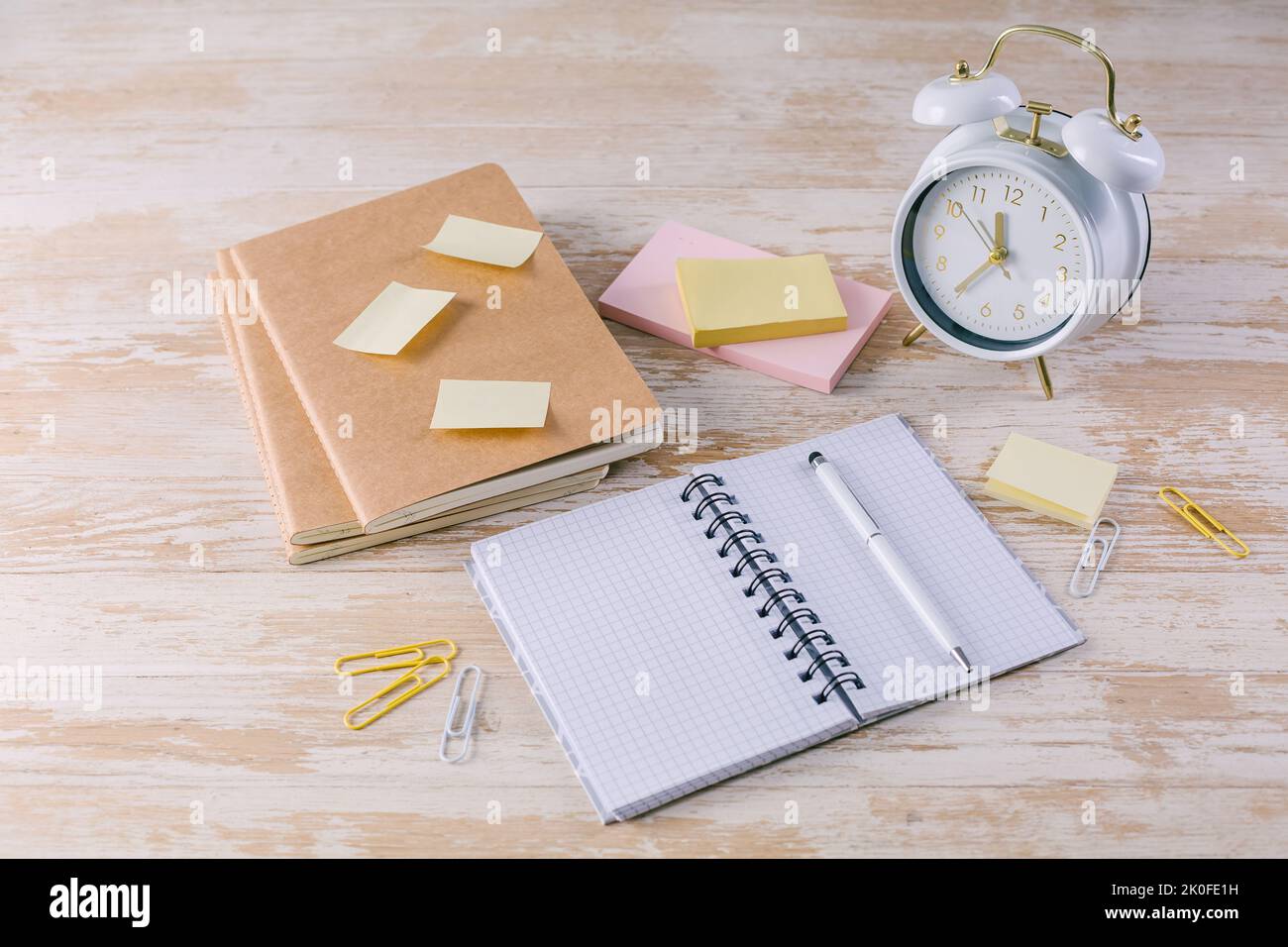 Concept of time management for office and school. Books, notepads with stickers Stock Photo