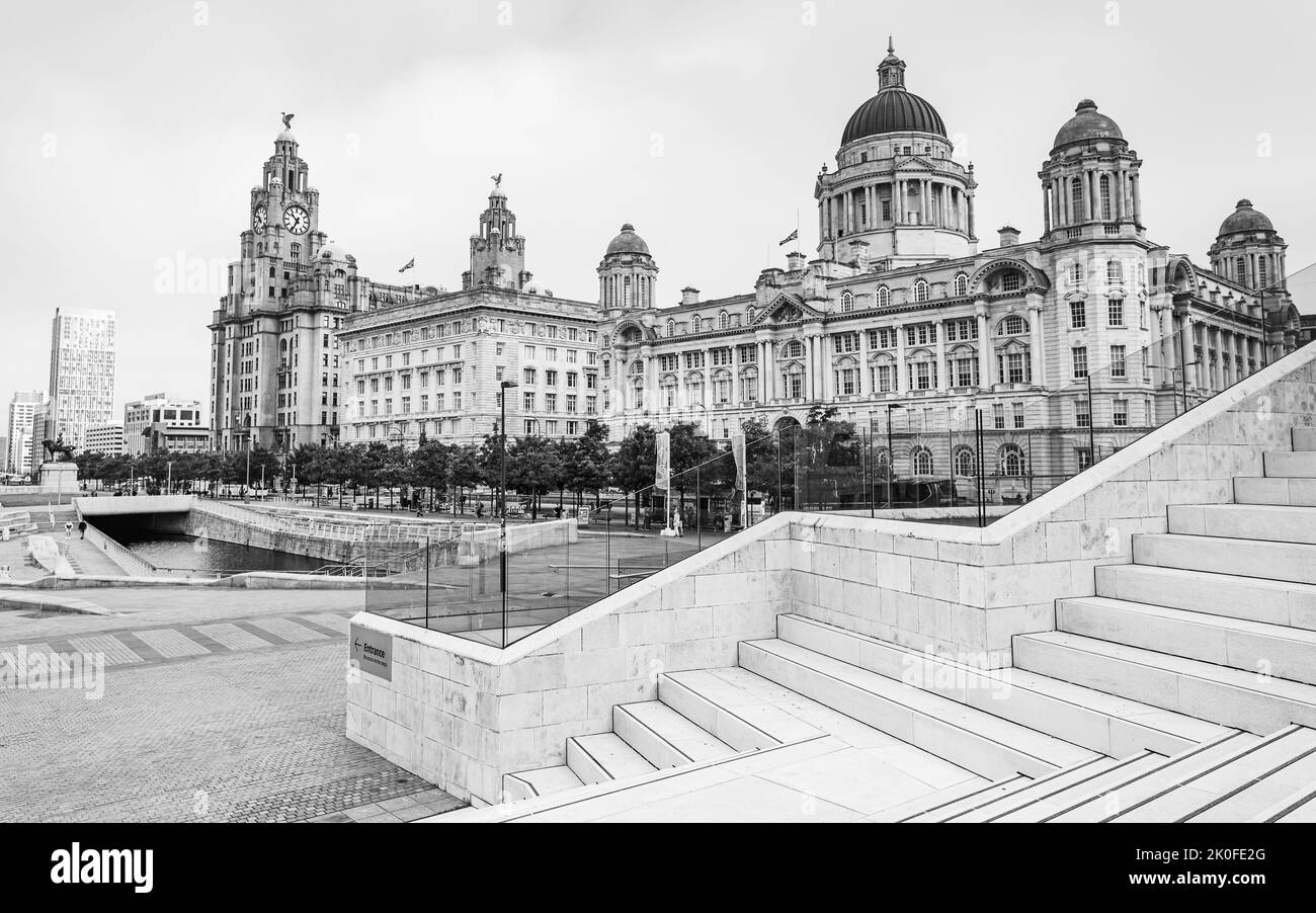 Modern abstract steps lead down to the Three Graces on the Liverpool skyline at Pier Head seen in September 2022. Stock Photo