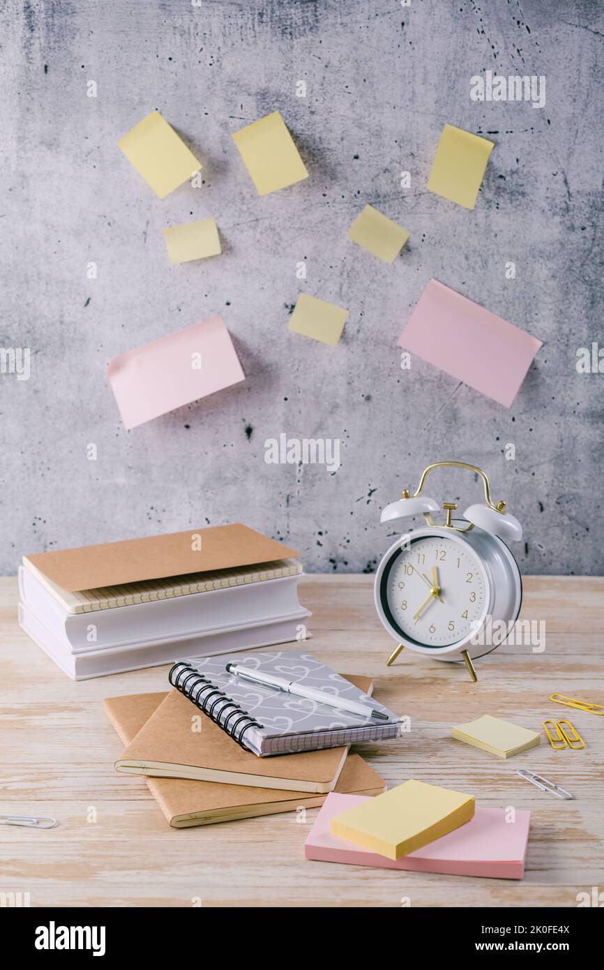 Concept of time management for office and school. Books, notepads with stickers Stock Photo