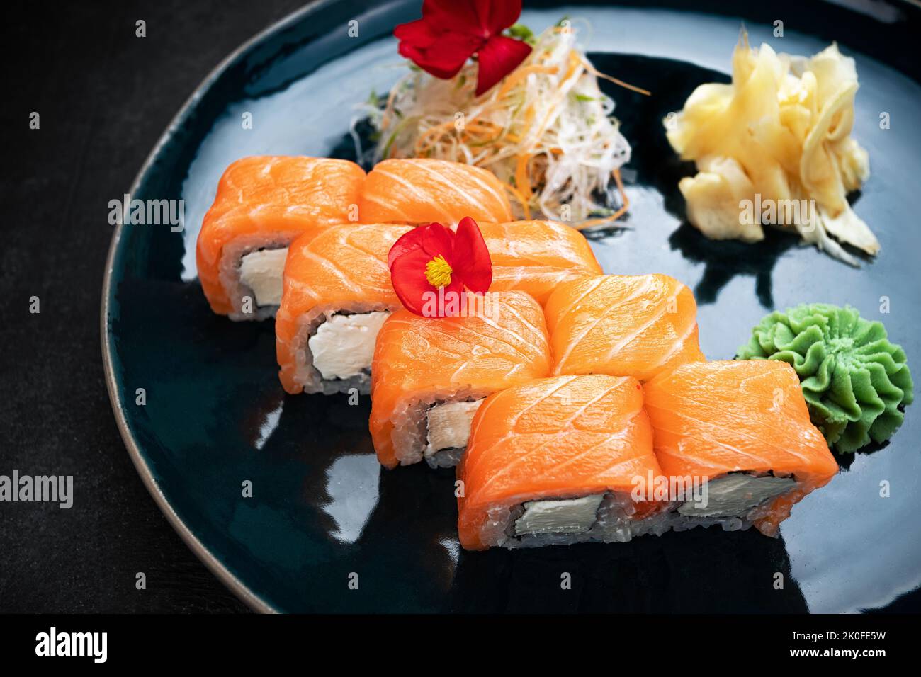 Sushi rolls Philadelphia with cheese and salmon, on a dark background Stock Photo
