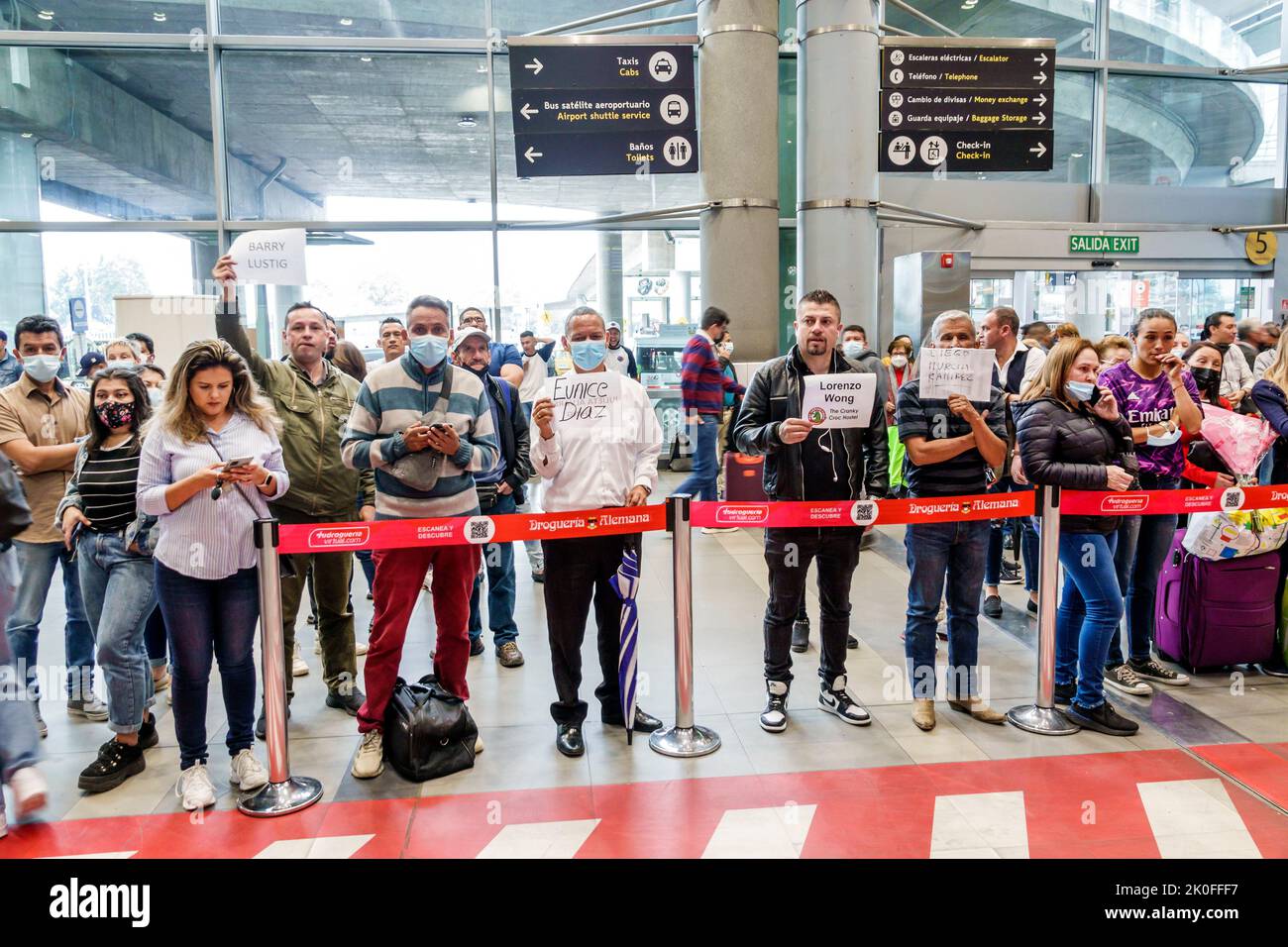 Bogota Colombia,El Dorado International Airport Aeropuerto Internacional El Dorado terminal inside interior,arrival door meeting passengers holding na Stock Photo