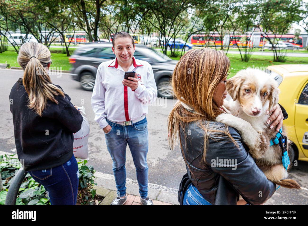 Bogota Colombia,Avenida El Dorado Calle 26,woman holding dog pet,man men male woman women female,Colombian Colombians Hispanic Hispanics South America Stock Photo