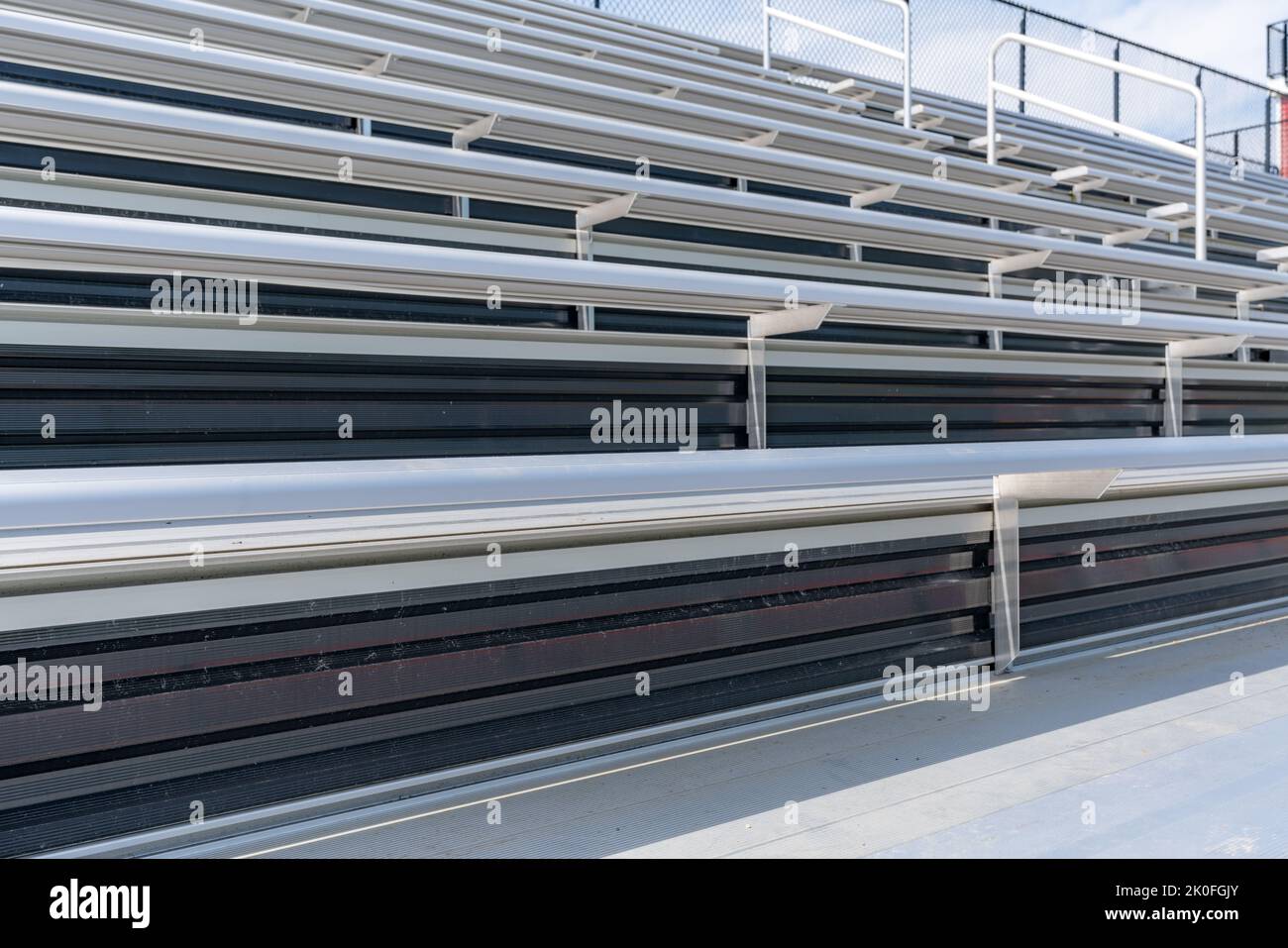 Close-Up of empty metal stadium bleacher bench seats. Nondescript location with no people in image. Not a ticketed event. Stock Photo