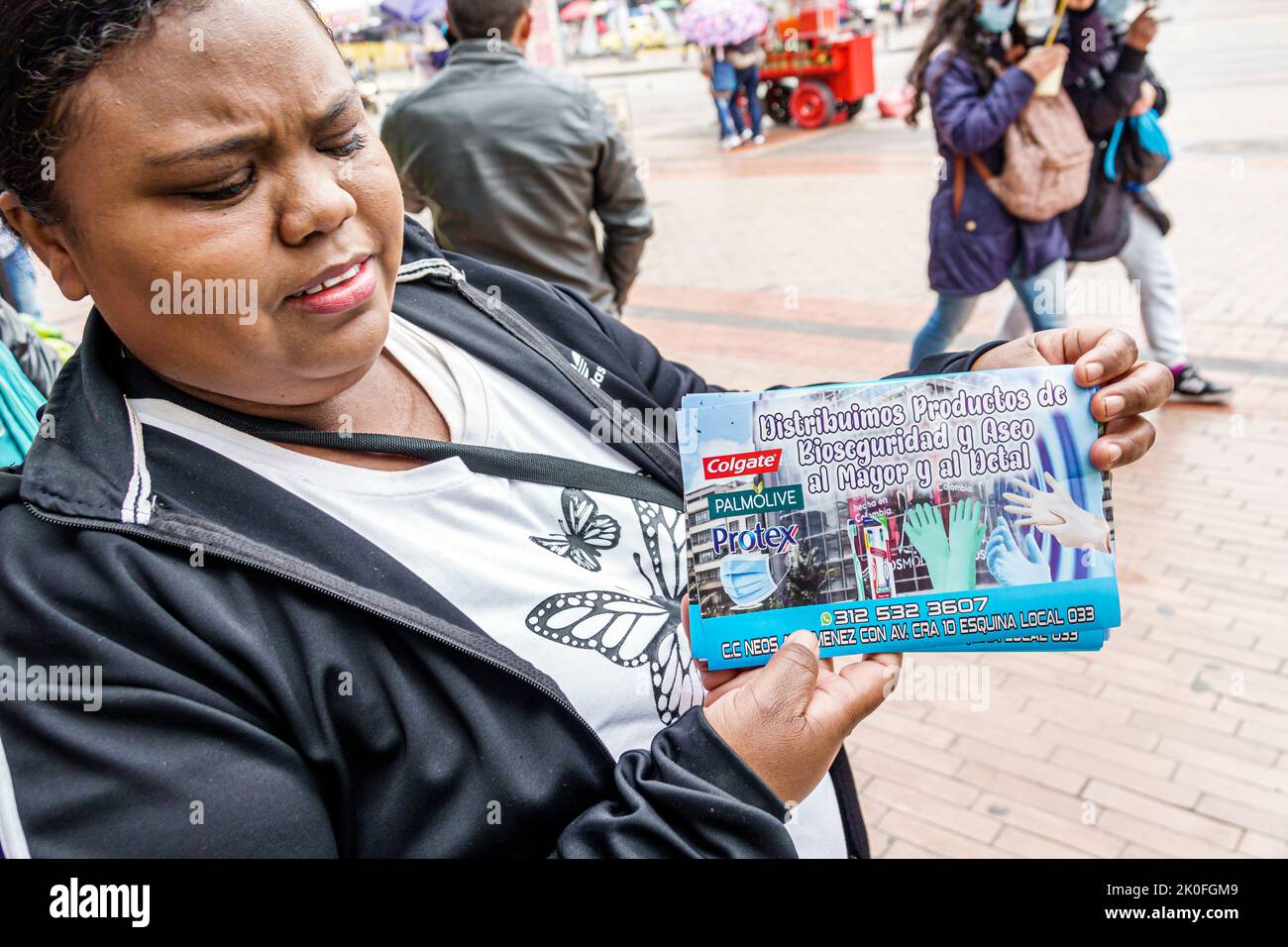 Bogota Colombia,San Victorino Carrera 10,Centro downtown handout handing out Black African female woman flyer information advertising ad Spanish langu Stock Photo
