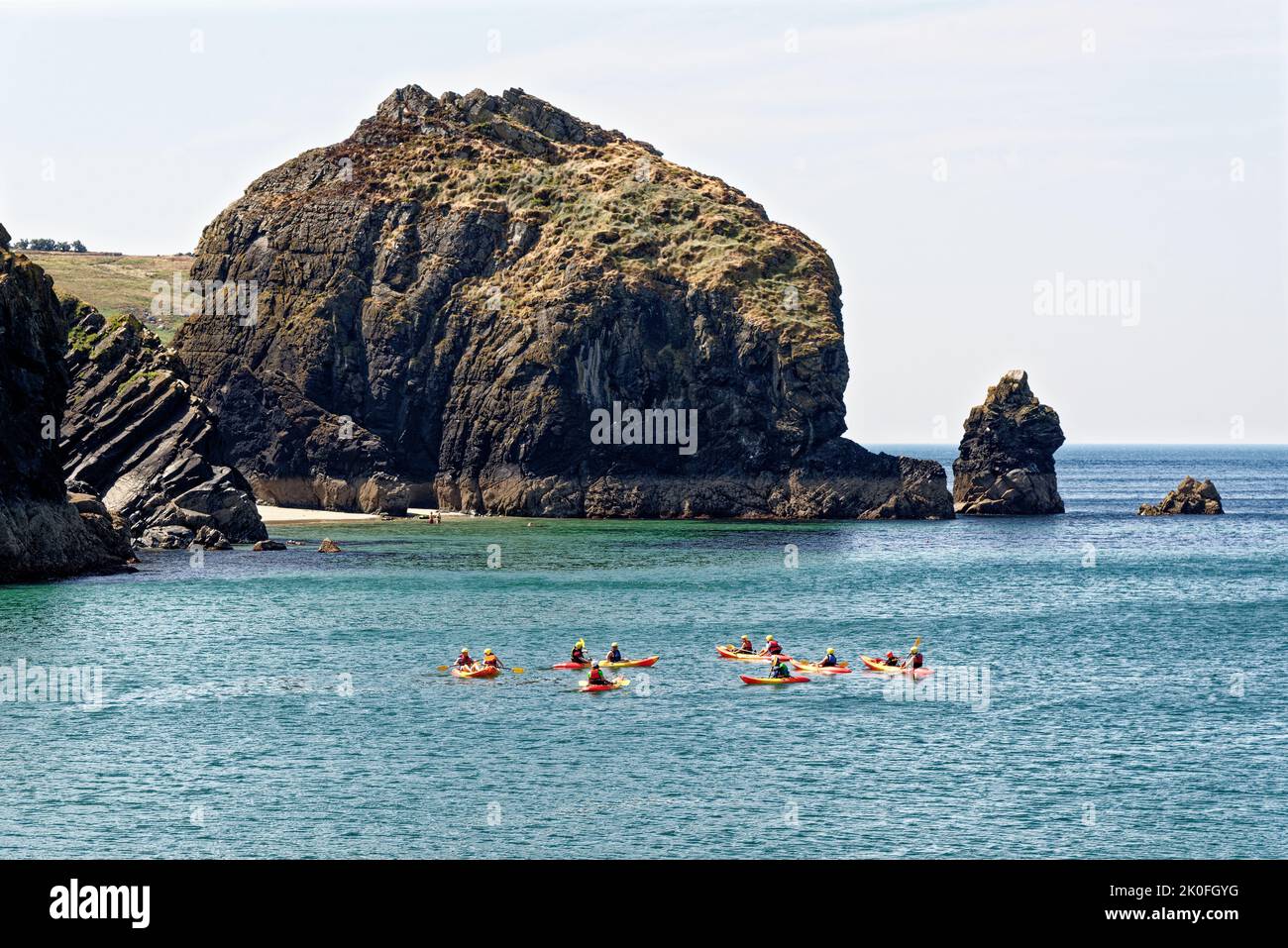 kayaking in Historic harbour at Mullion Cove in Mounts Bay Cornwall England UK. 13th of August 2022. Mullion Cove or Porth Mellin - port on the west c Stock Photo