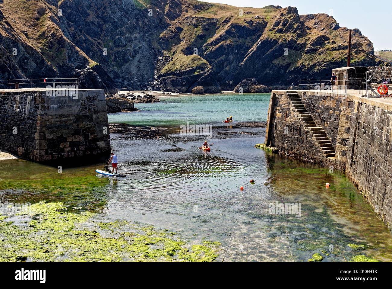 kayaking in Historic harbour at Mullion Cove in Mounts Bay Cornwall
