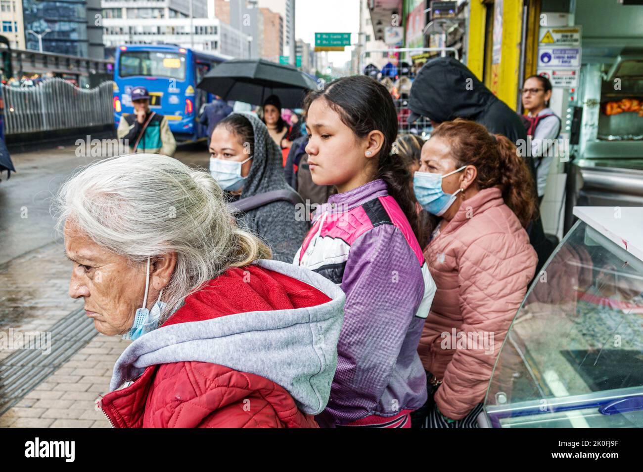 Bogota Colombia,San Victorino Carrera 10 Transmilenio bus stop,senior woman women female girl girls waiting looking,Colombian Colombians Hispanic Hisp Stock Photo