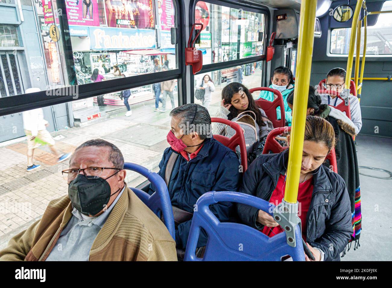Bogota Coombia,riding Transmilenio bus route D206 Carrera 10,man men male woman women female,rider riders riding passenger passengers inside interior, Stock Photo