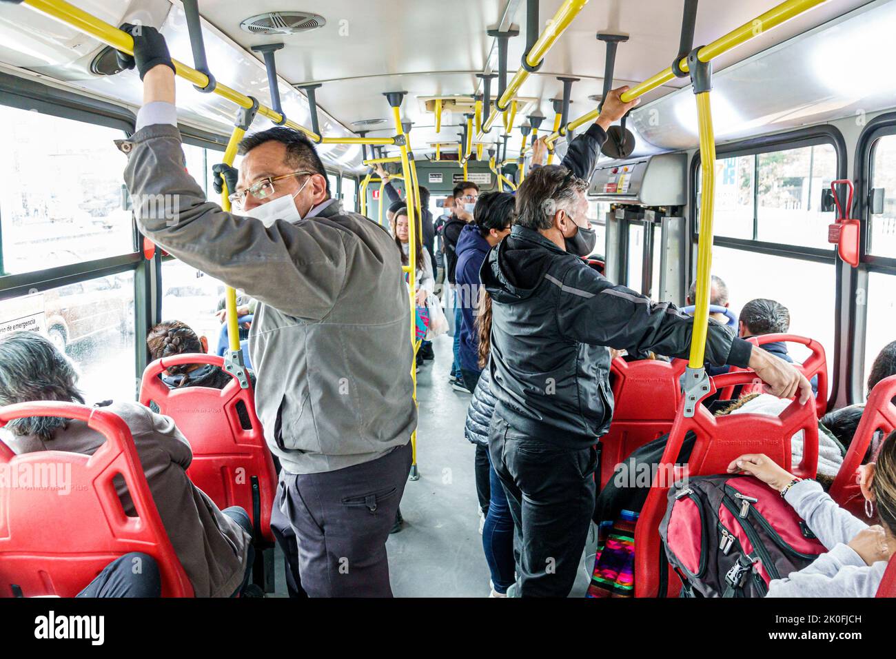 Bogota Coombia,riding Transmilenio bus route D206 Carrera 10,man men male woman women female,rider riders riding passenger passengers inside interior Stock Photo