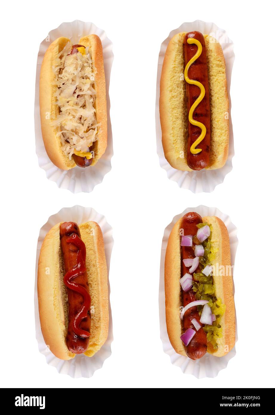 Four different hotdogs on paper holders with different condiment toppings isolated on white. Stock Photo