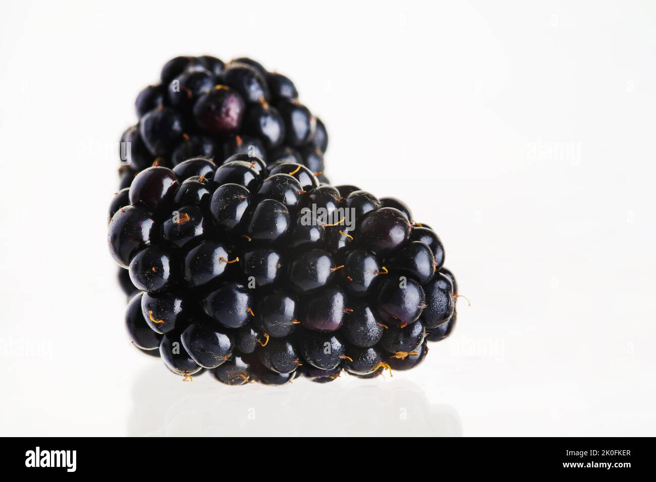 Close-up. Blackberry on a white background. Ripe juicy berries. Vitamins, sweet healthy dessert. Shop, farm, patisserie, restaurant, hotel, home cooki Stock Photo