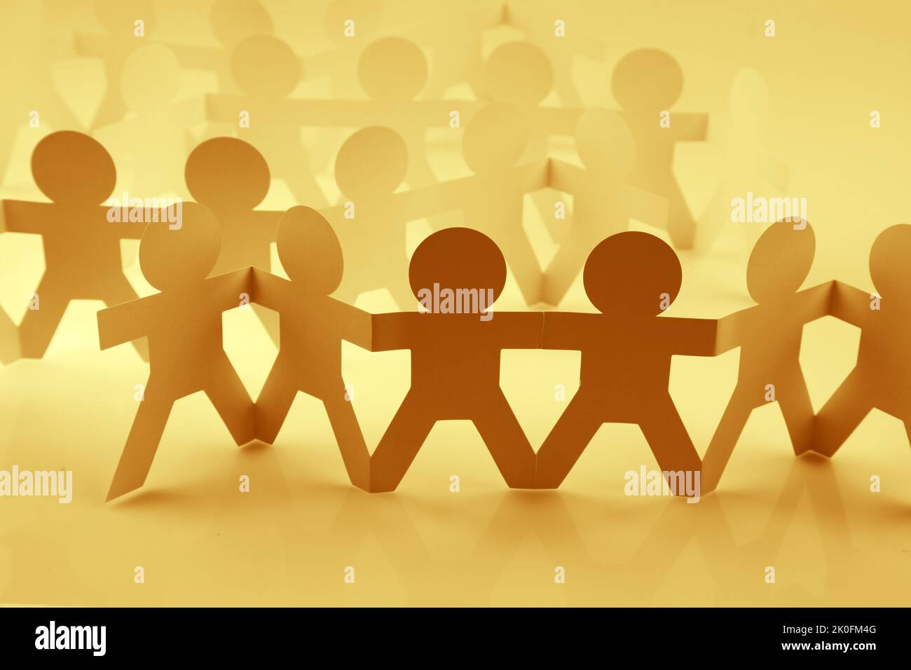 Paper chain team holding hands. Teamwork. Partnership Stock Photo