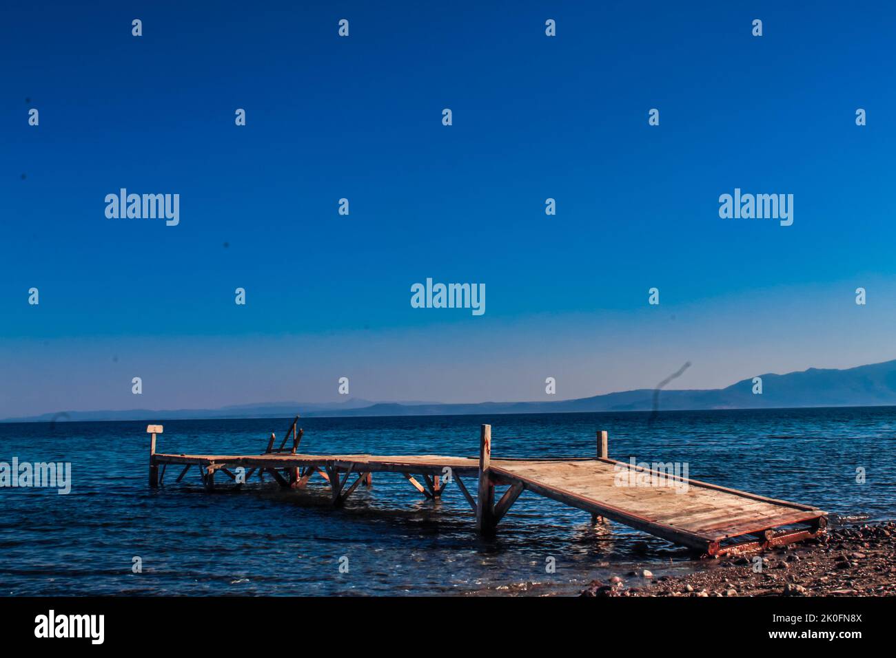 Cunda, Balikesir, Turkey - July 2022: Wooden pier extending to the sea in Cunda peninsula, selective focus Stock Photo