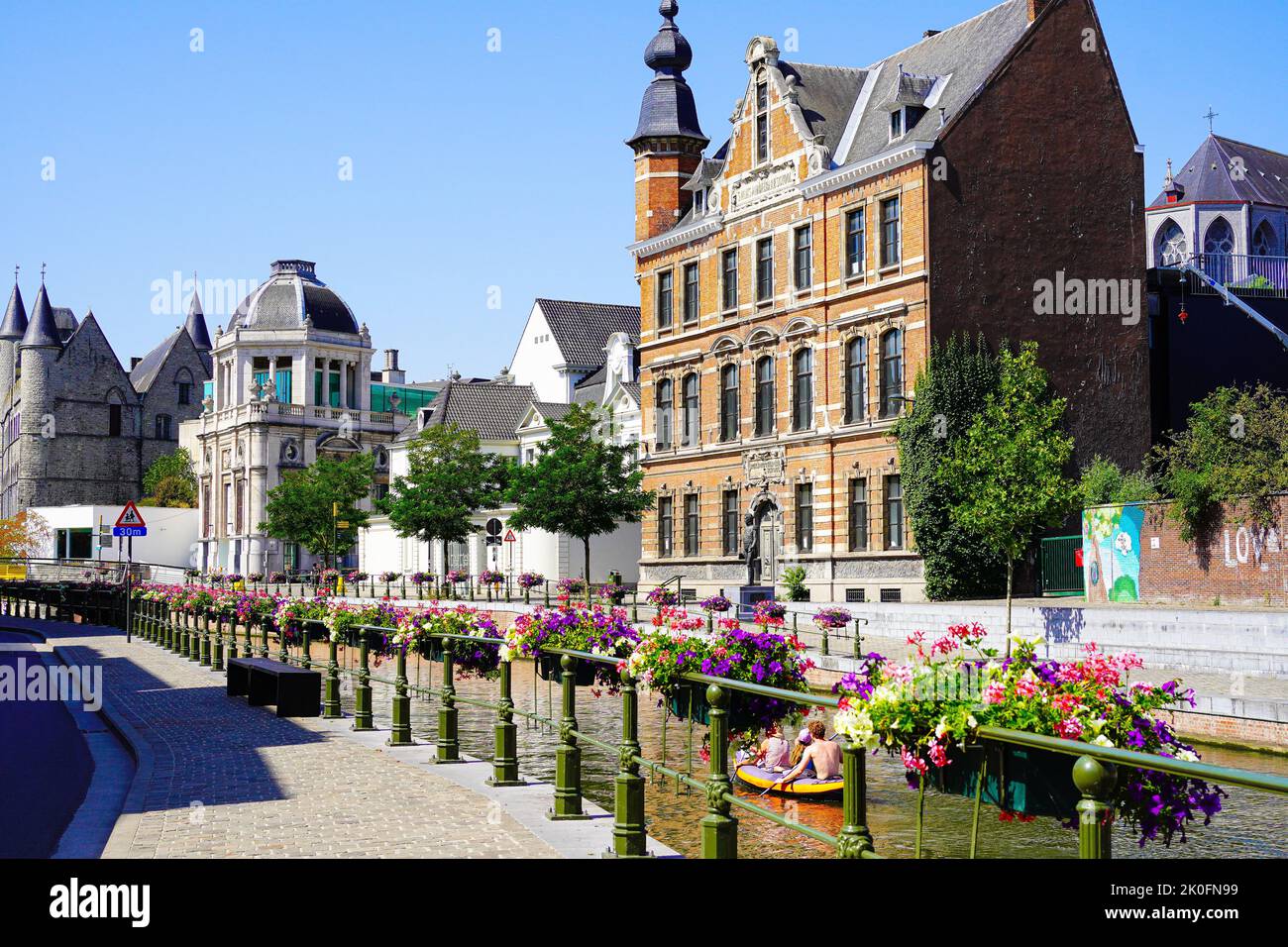 Beautiful canal decorated with flowers in Ghent , Belgium Stock Photo