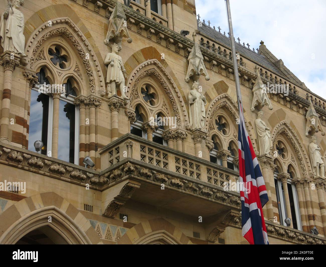 The Union Jack flag is flying at half-mast at the Guildhall in Northampton, the ornate civic building for the Town Council. Stock Photo