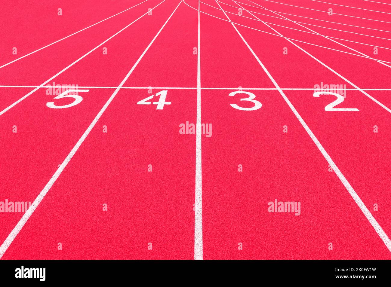 Red track and field lanes and numbers. Running lanes at a track and