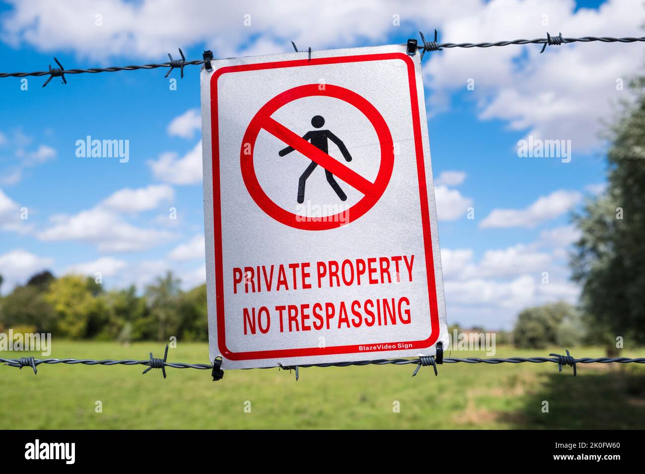 'Private Property No Trespassing' sign on a field boundary. Suffolk, UK. Stock Photo