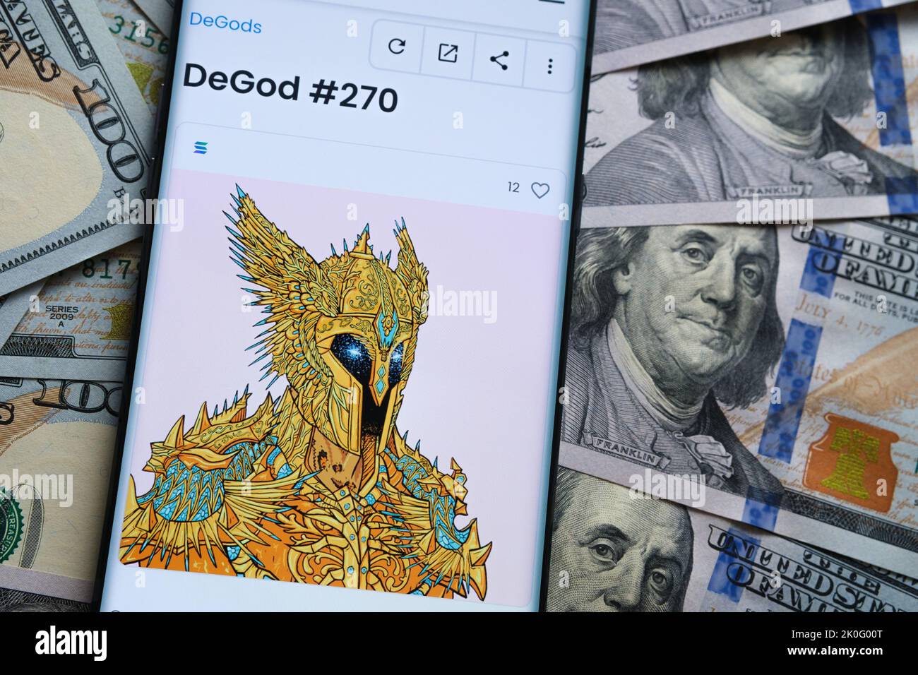 NFT DeGod #270 digital artwork on OpenSea marketplace seen on the smartphone screen which is placed on dollar bills. Concept. Stafford, United Kingdom Stock Photo
