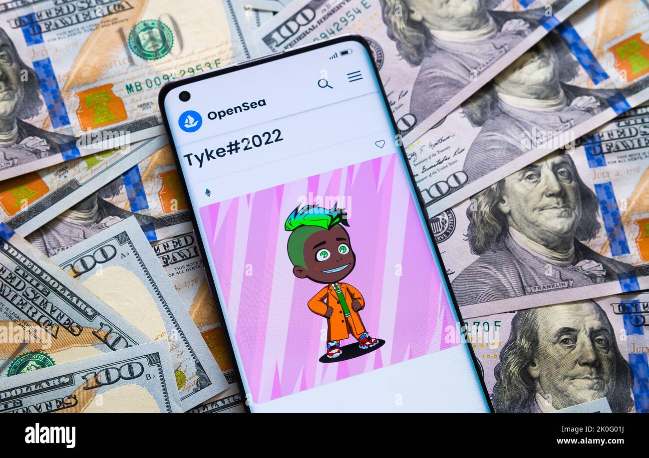 NFT Tyke #2022 from Tykes collection seen on Opensea marketplace on smartphone screen which is placed on dollar banknotes. Stafford, United Kingdom, S Stock Photo