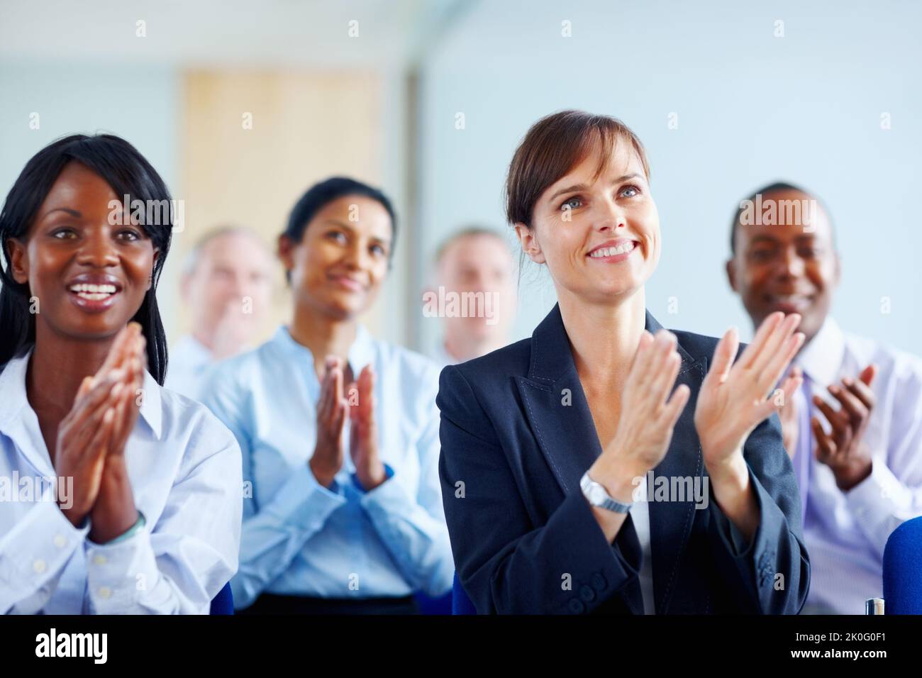 Colleagues applauding presentation. View of group of executives applauding. Stock Photo