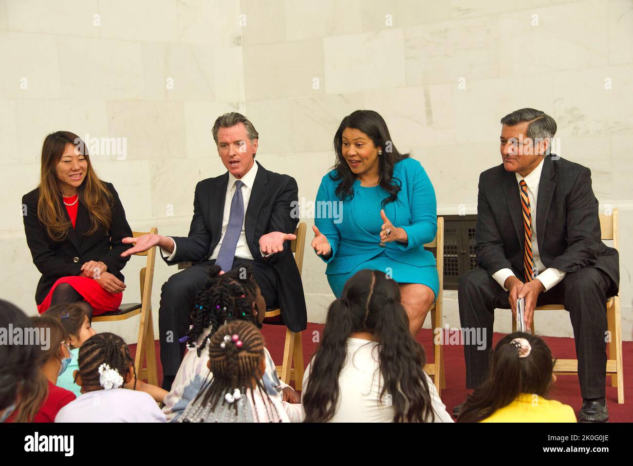 San Francisco, CA - April 26, 2022: Treasurer Ma, Governor Newsom, Mayor Breed and Treasurer Cisneros speak with children from Bryant Elementary Schoo Stock Photo
