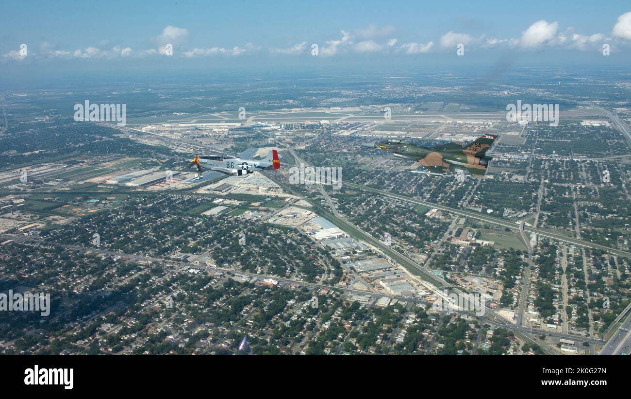 An F-16 Fighting Falcon, assigned to the 149th Fighter Wing, flies with a P-51 Mustang over San Antonio, Texas for the Air Force's 75th Anniversary on Sept. 10, 2022. To honor the anniversary the 149th FW conducted a joint flight with a P-51 which was the second model aircraft to be used at the unit. (U.S. Air Force photo by Staff Sergeant James R. Crow) Stock Photo