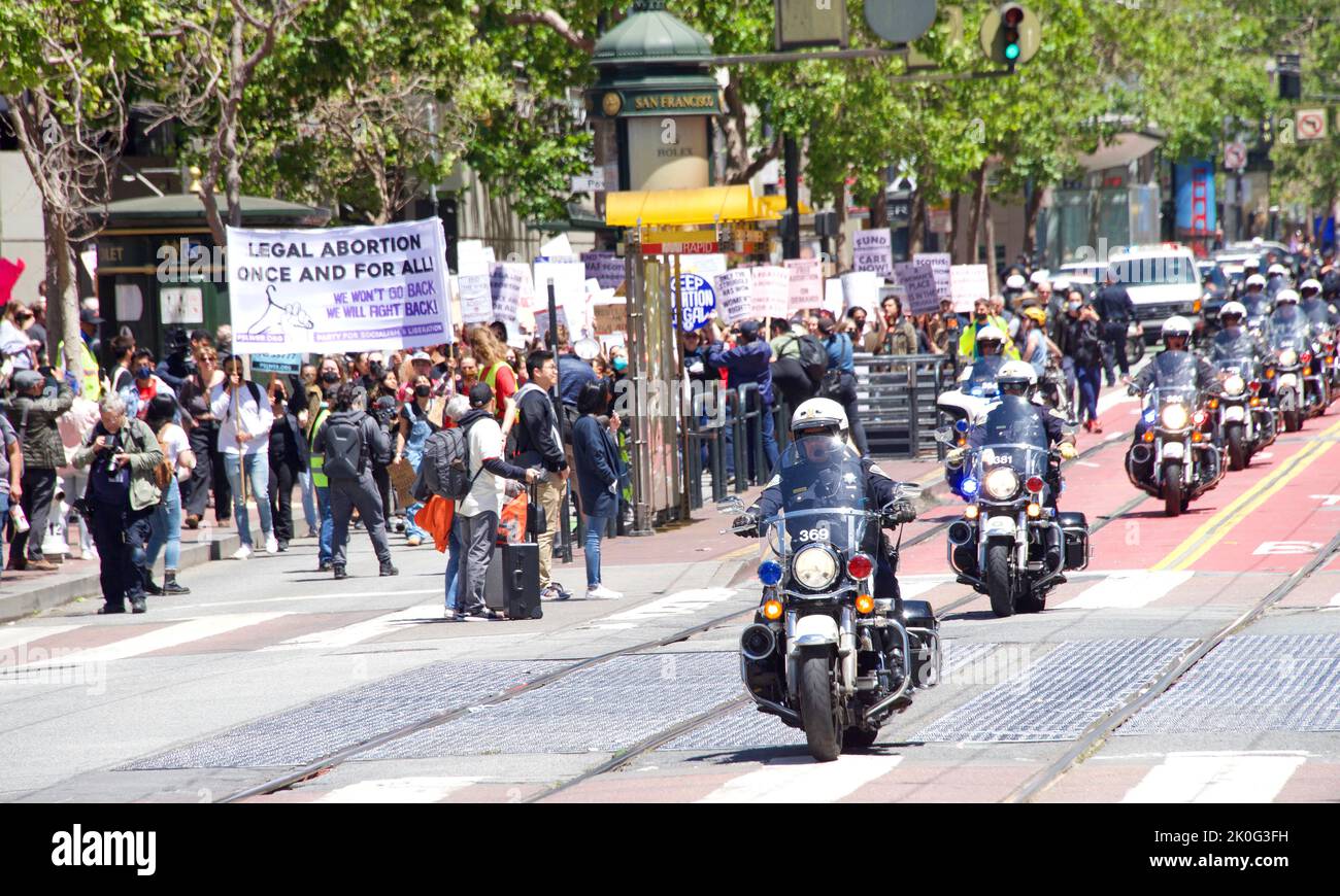 San Francisco, CA - May 7, 2022: Unidentified Participants holding signs marching in San Francisco at Women’s Rights Protest after SCOTUS leak plan to Stock Photo