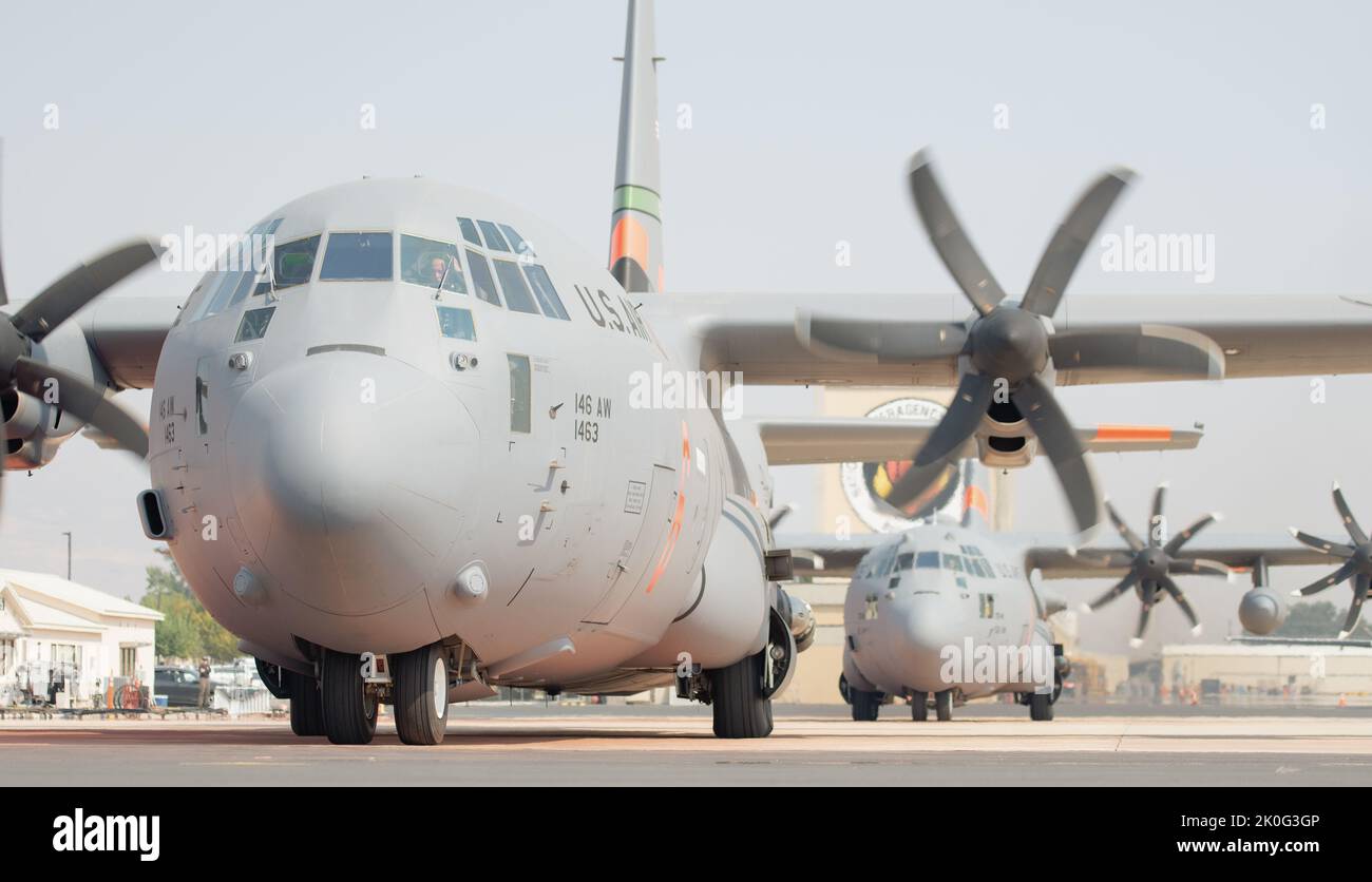 Two Modular Airborne Firefighting Systems (MAFFS) equipped C-130 aircraft from the Nevada Air National Guard’s 152nd Airlift Wing and the California Air National Guard’s 146th Airlift Wing prepare to be launched on a fire suppression mission at the Boise Tanker Base, Idaho, September 10, 2022. The United States Department of Agriculture Forest Service activated two Department of Defense C-130 aircraft equipped with MAFFS to assist with increased fire activity in several western states. (U.S. Air National Guard photo by Senior Airman Thomas Cox) Stock Photo
