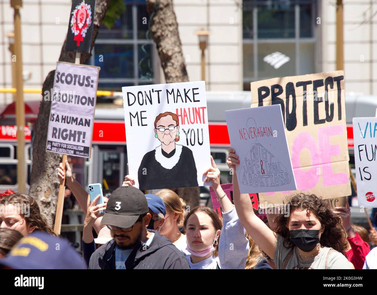 San Francisco, CA - May 7, 2022: Unidentified Participants holding signs marching in San Francisco at Women’s Rights Protest after SCOTUS leak plan to Stock Photo