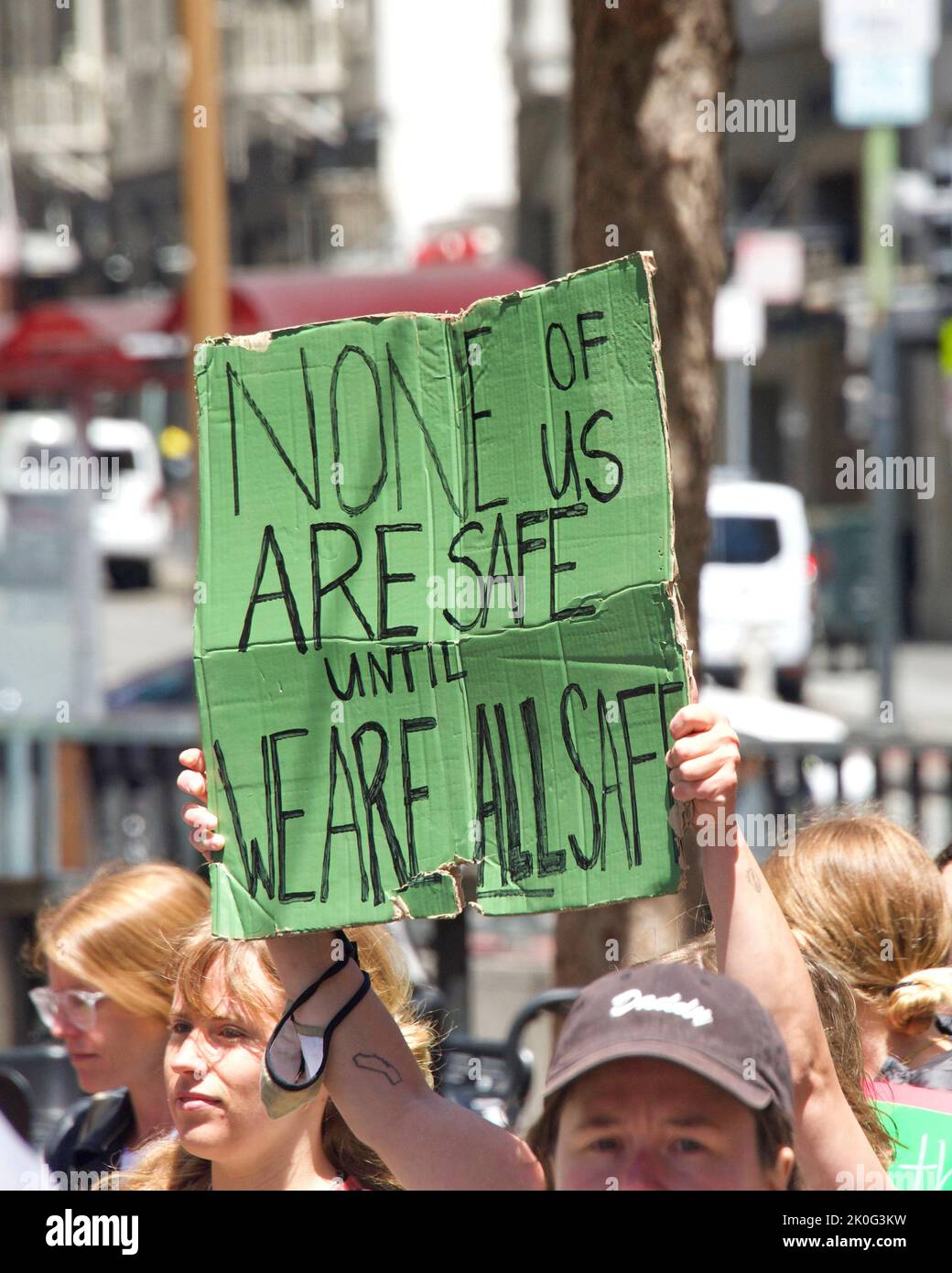 San Francisco, CA - May 7, 2022: Unidentified Participants holding signs marching in San Francisco at Women’s Rights Protest after SCOTUS leak plan to Stock Photo