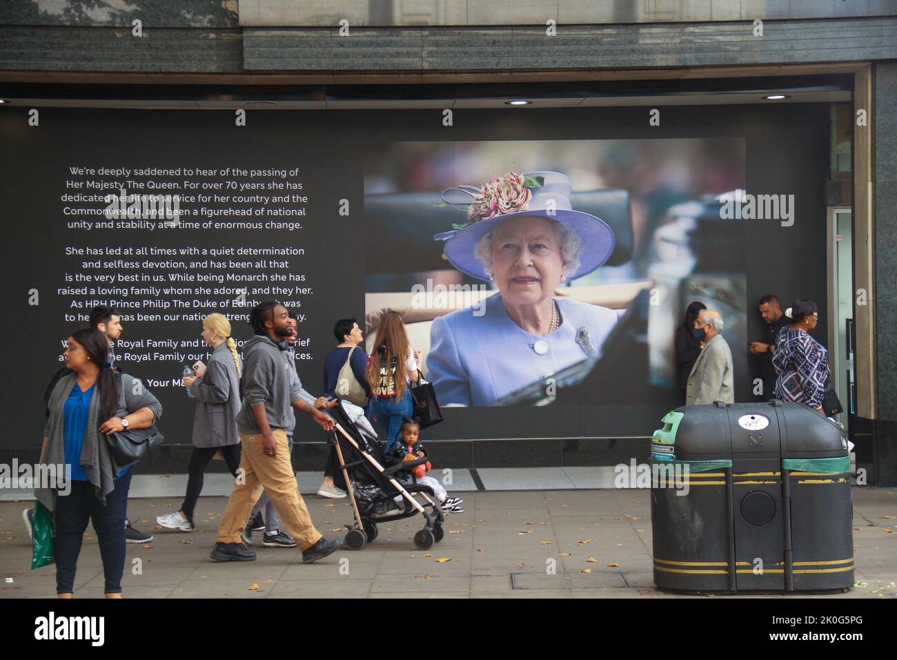 Pedestrians walk past a billboard on Oxford street in memory of Queen Elizabeth ll. Queen Elizabeth II was queen regnant of 32 sovereign states during her lifetime, 15 at the time of her death. Her reign of 70 years and 214 days was the longest of any British monarch and the longest recorded of any female head of state in history. Stock Photo